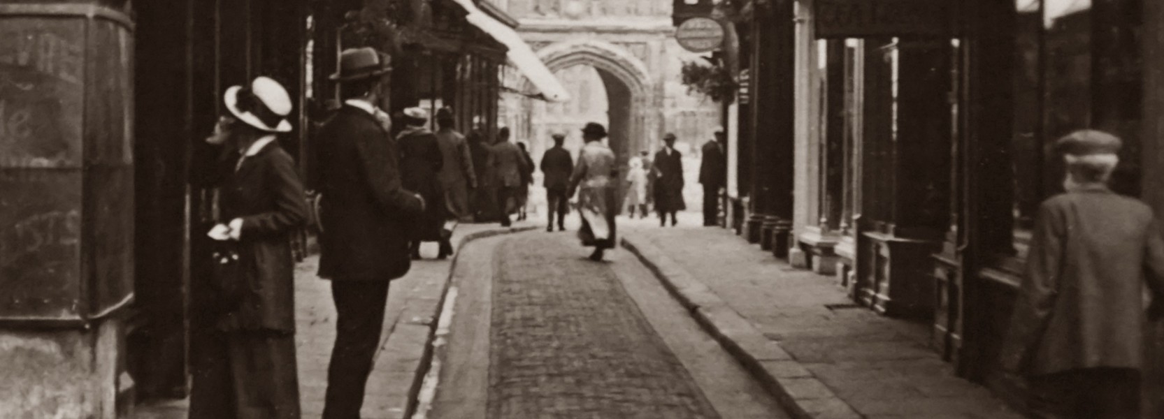 grey historical street with people walking around